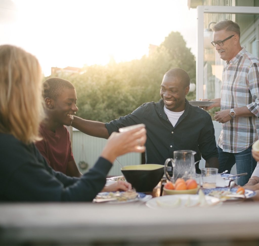 Friends sharing a meal and laughter around a table