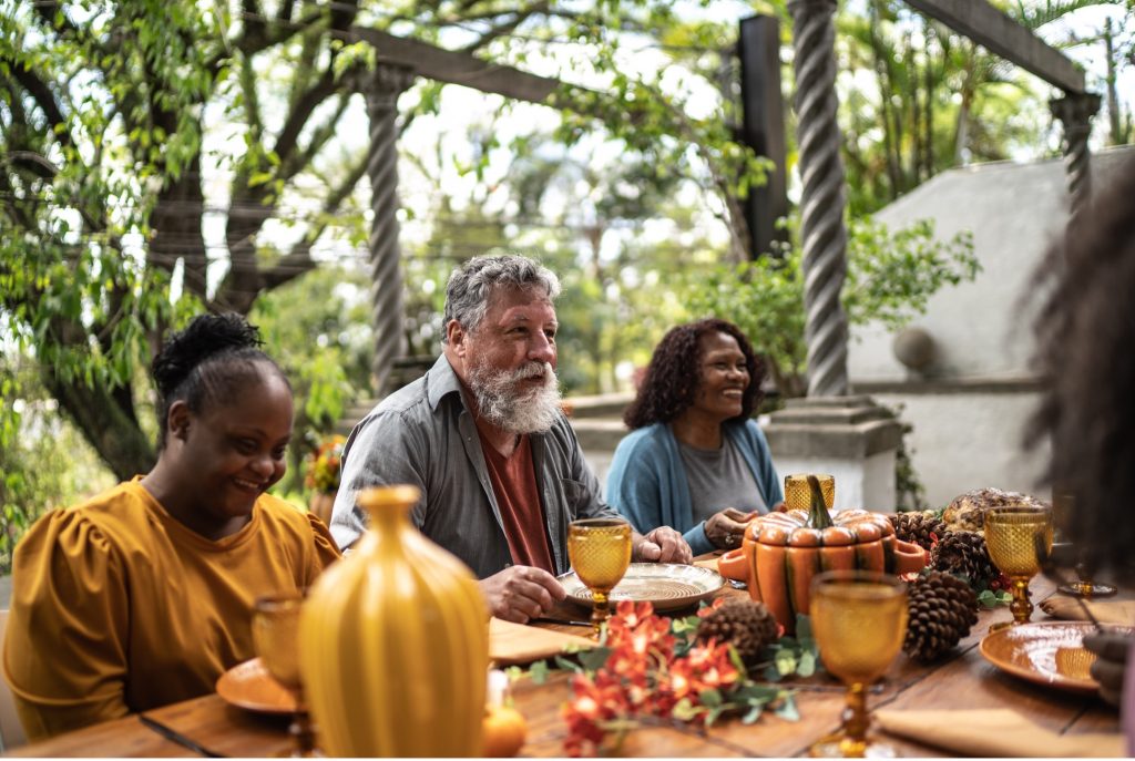 Friends sharing a meal and laughter around a table