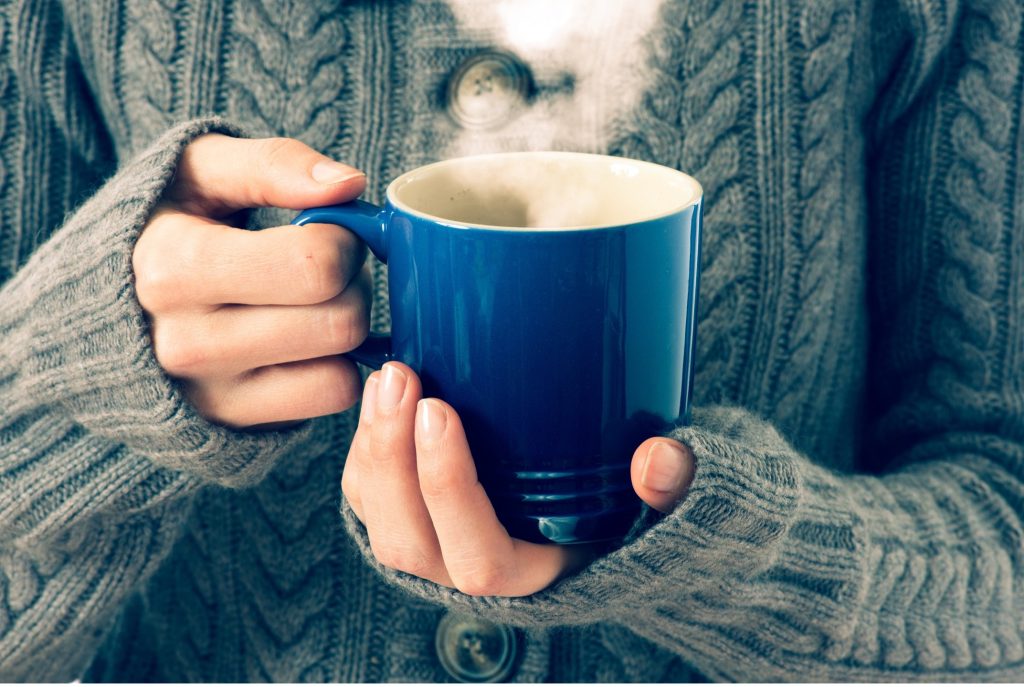 Hands wrapped around a warm mug